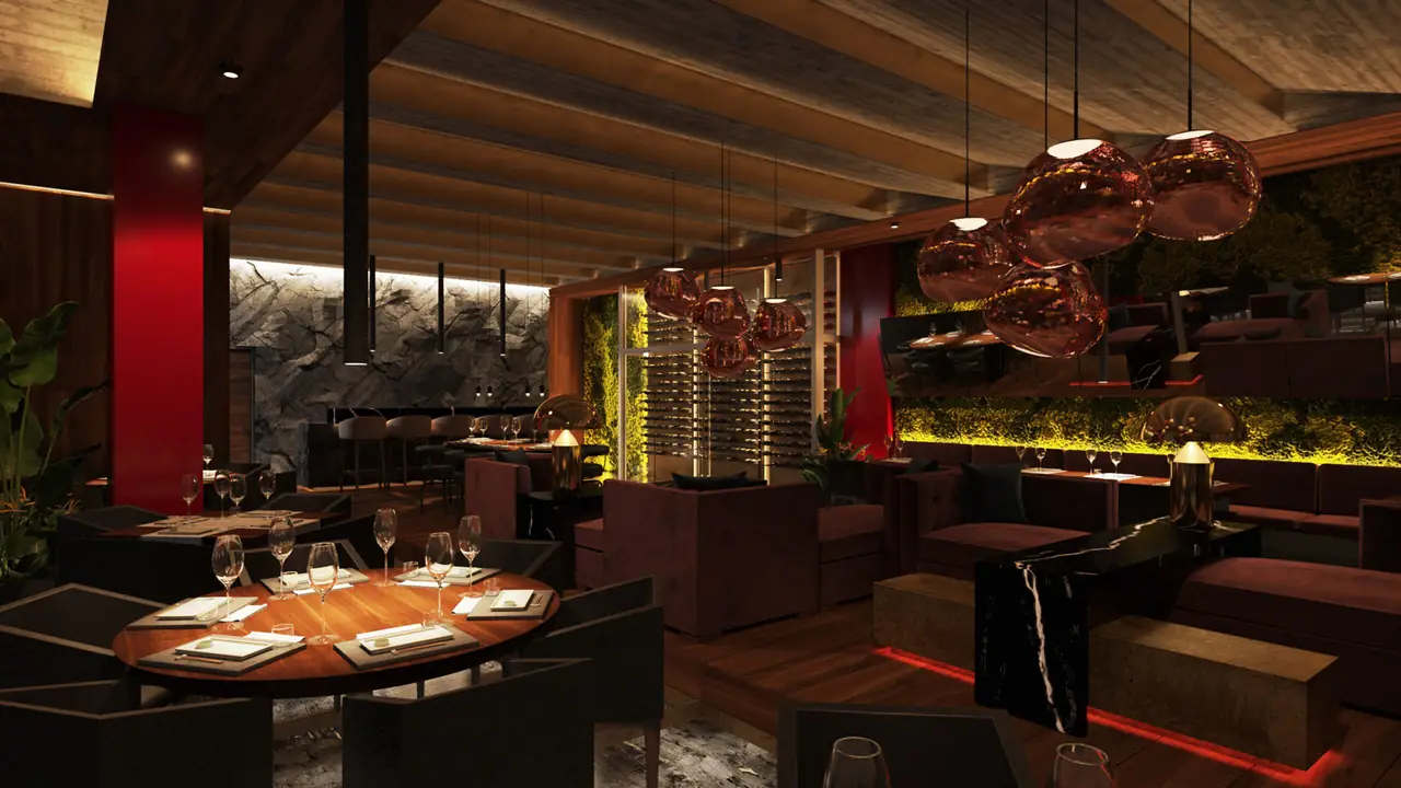 Dining room with dark wood ceiling, red accent column, copper pendant lamps, and tables set for service