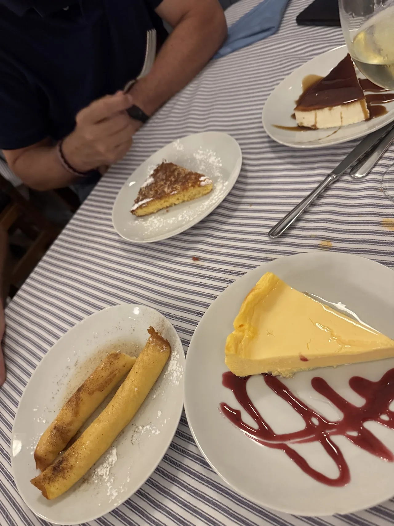 Assorted desserts including cheesecake and pastries on small plates