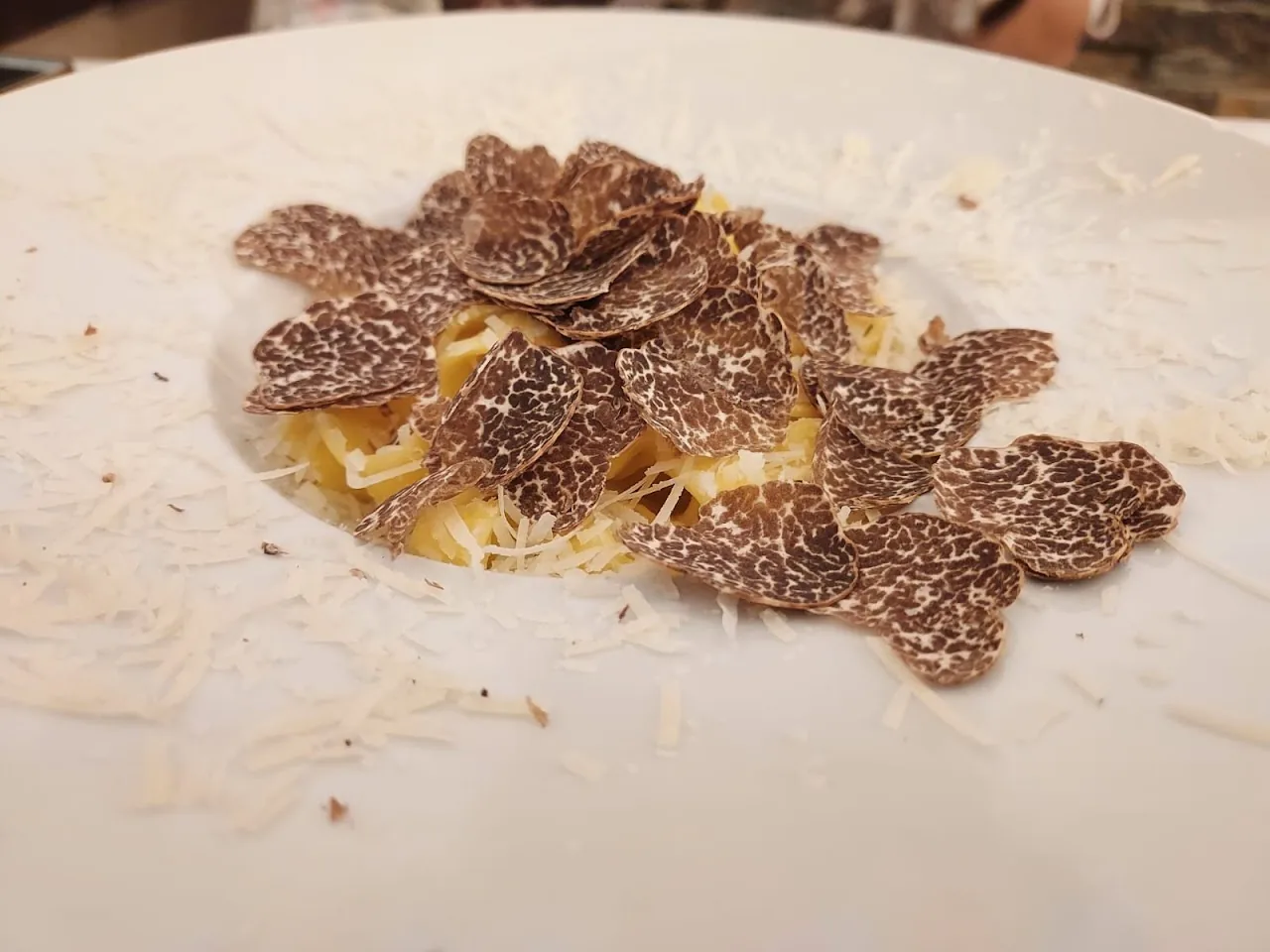 A plate of tagliatelle topped with shaved black truffle