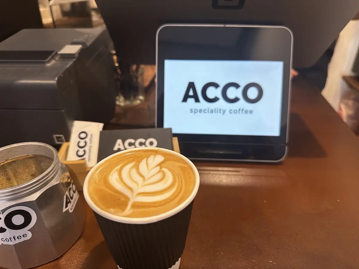 An Acco Speciality Coffee takeaway cup