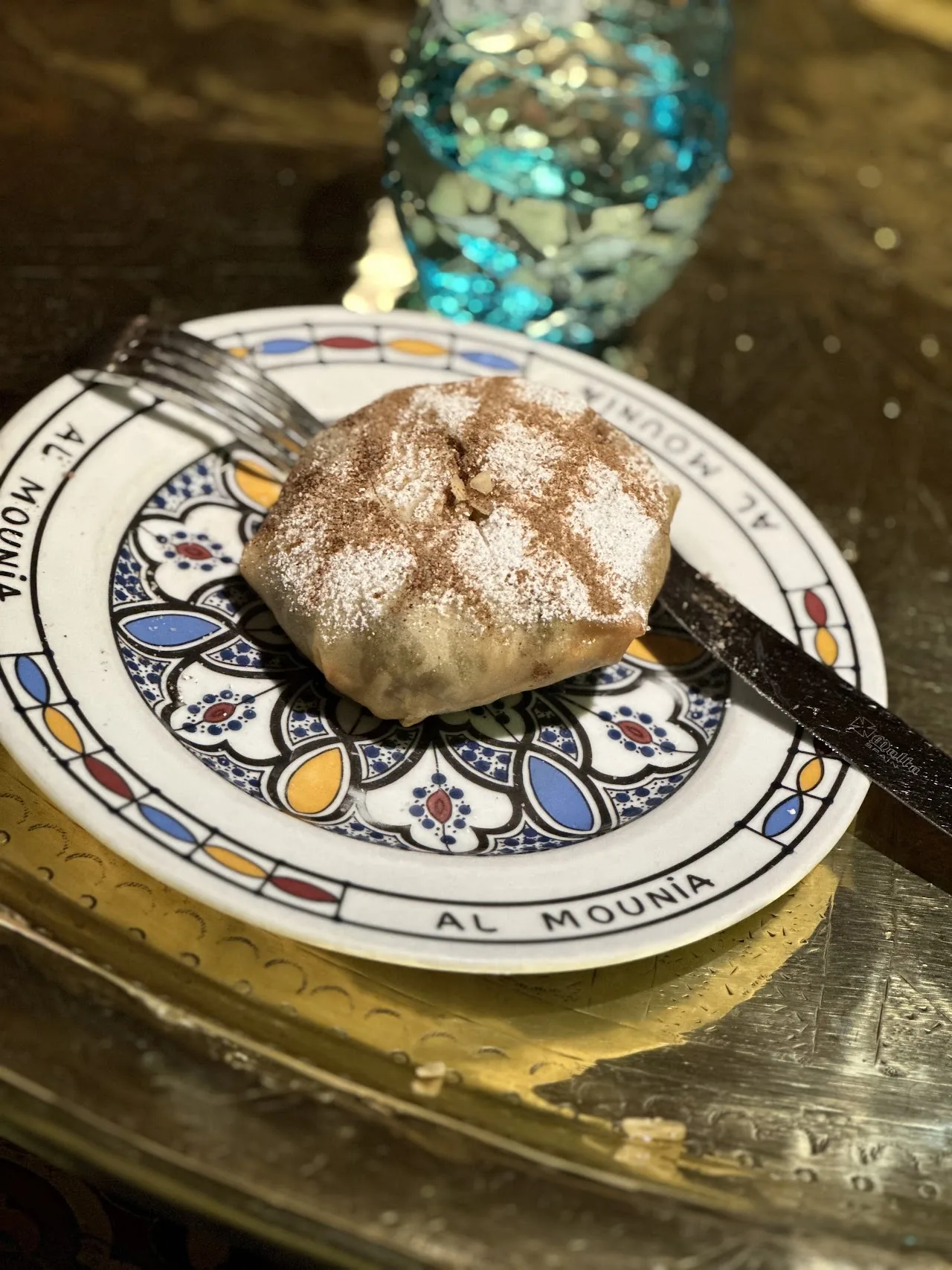 A powdered sugar-dusted Moroccan pastilla pastry