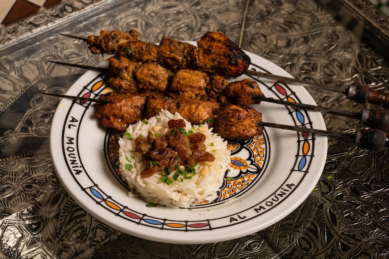 Grilled meat skewers over seasoned rice