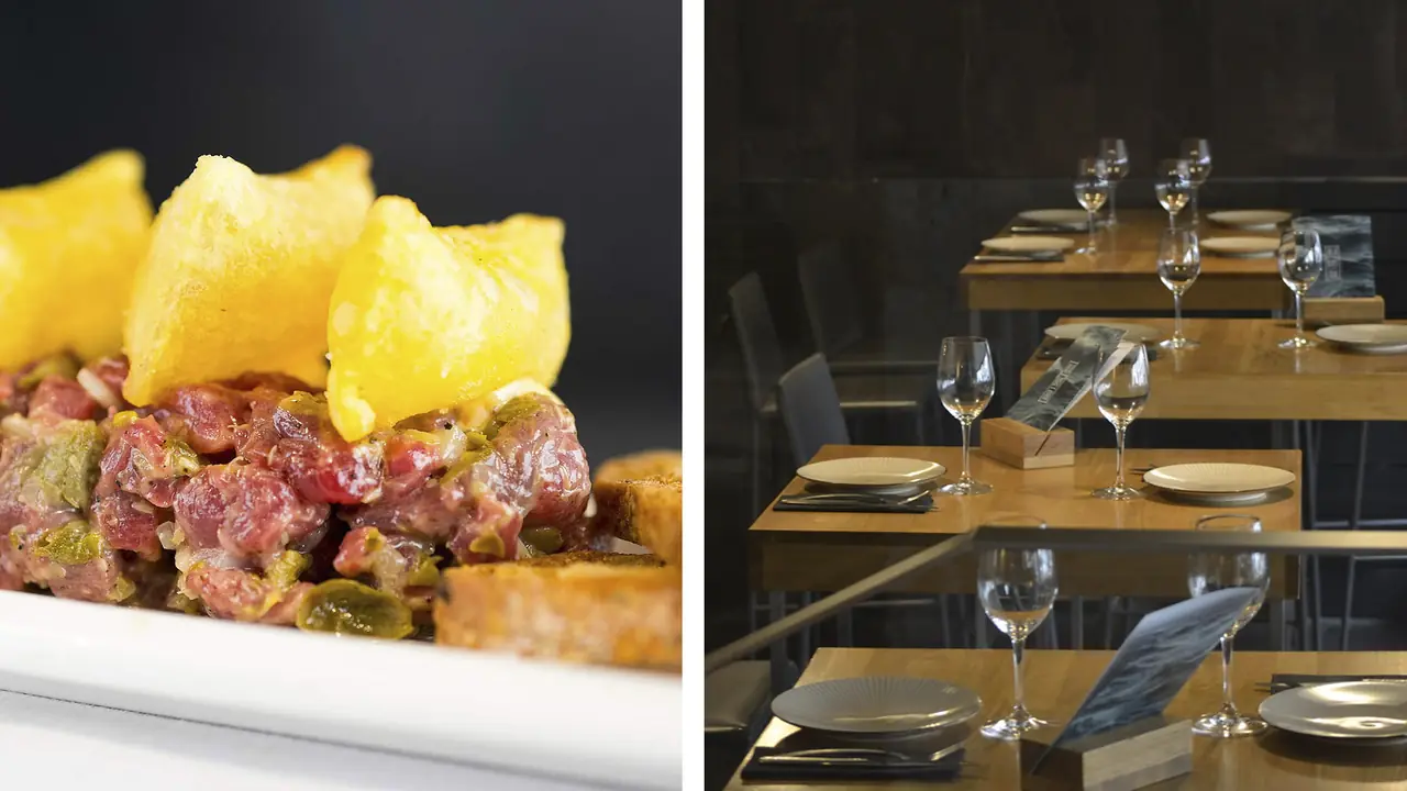 Beef tartare topped with crisps, served with grilled bread, next to an empty dining room