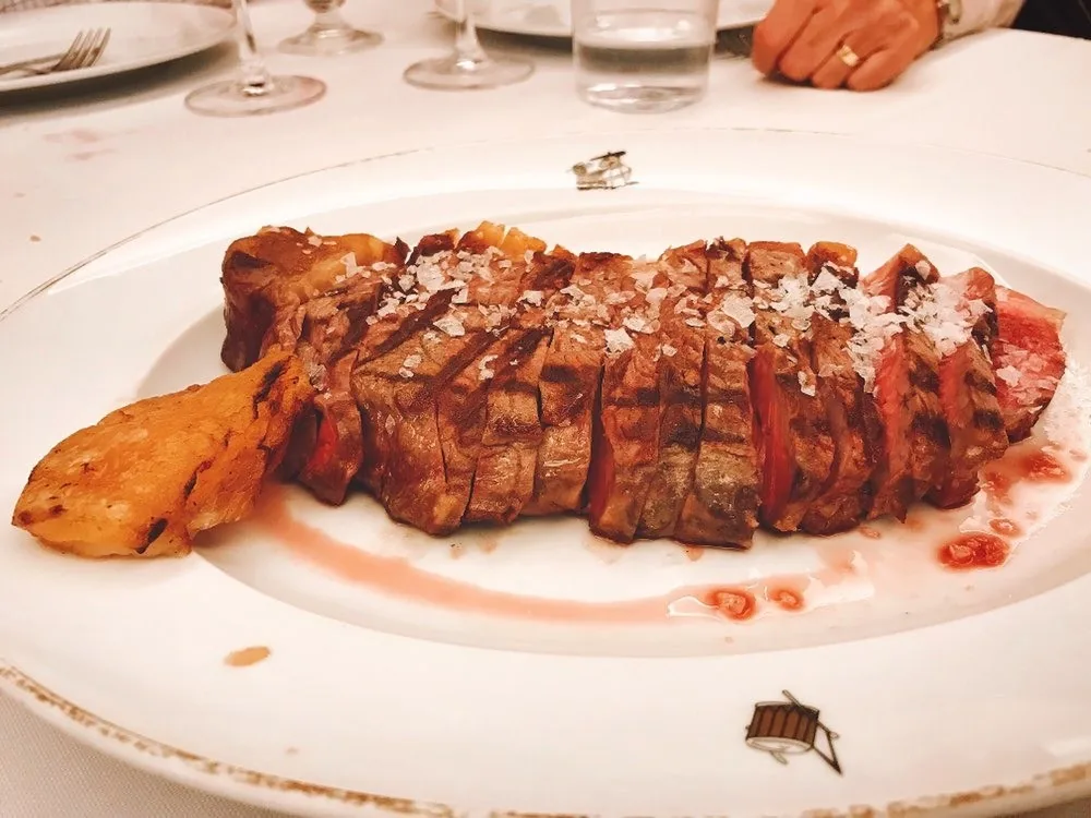 Sliced grilled steak on a white plate