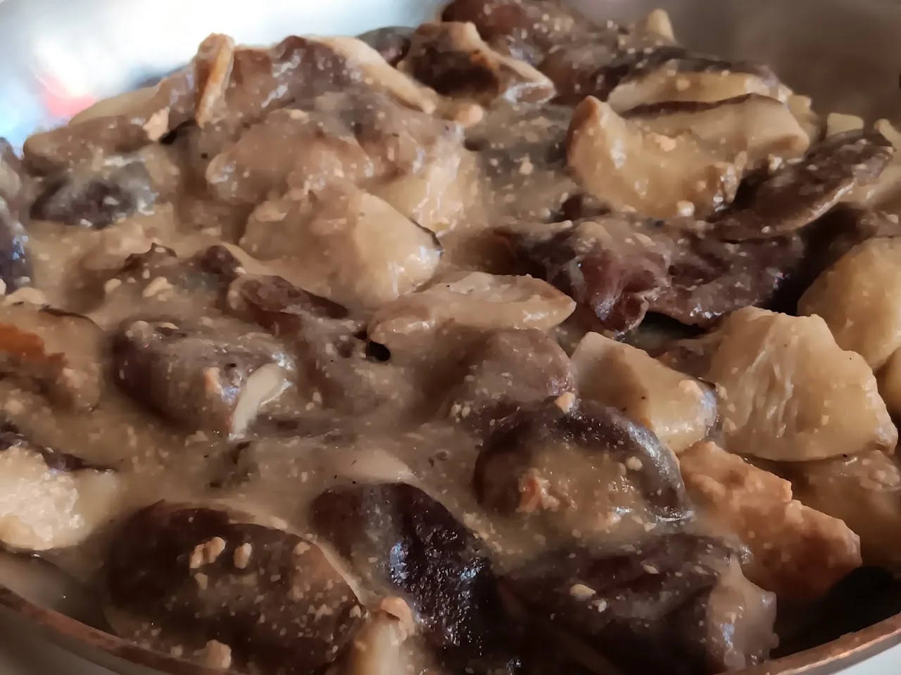 A close-up of a creamy wild mushroom and garlic stew