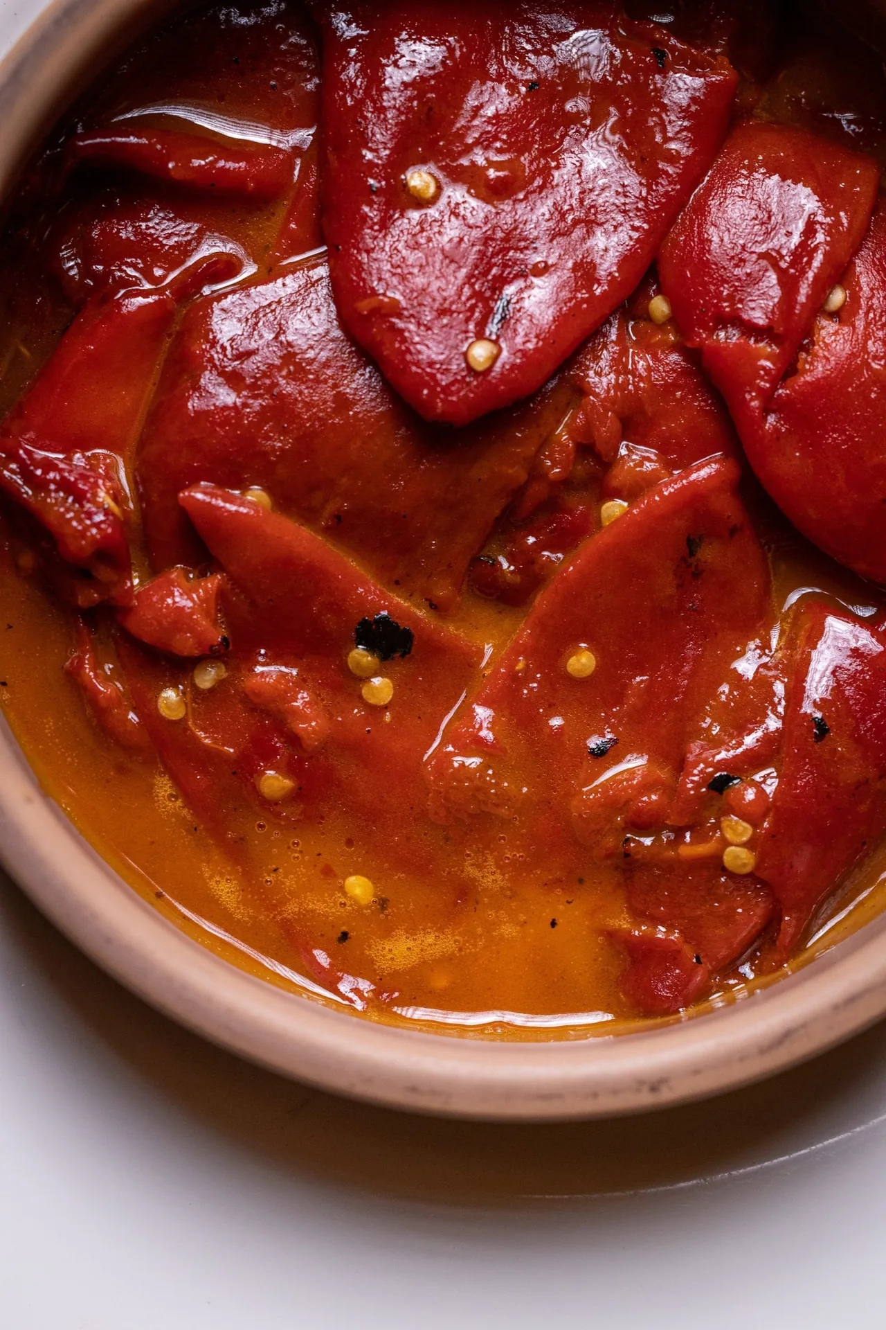 Roasted red peppers in a terracotta dish