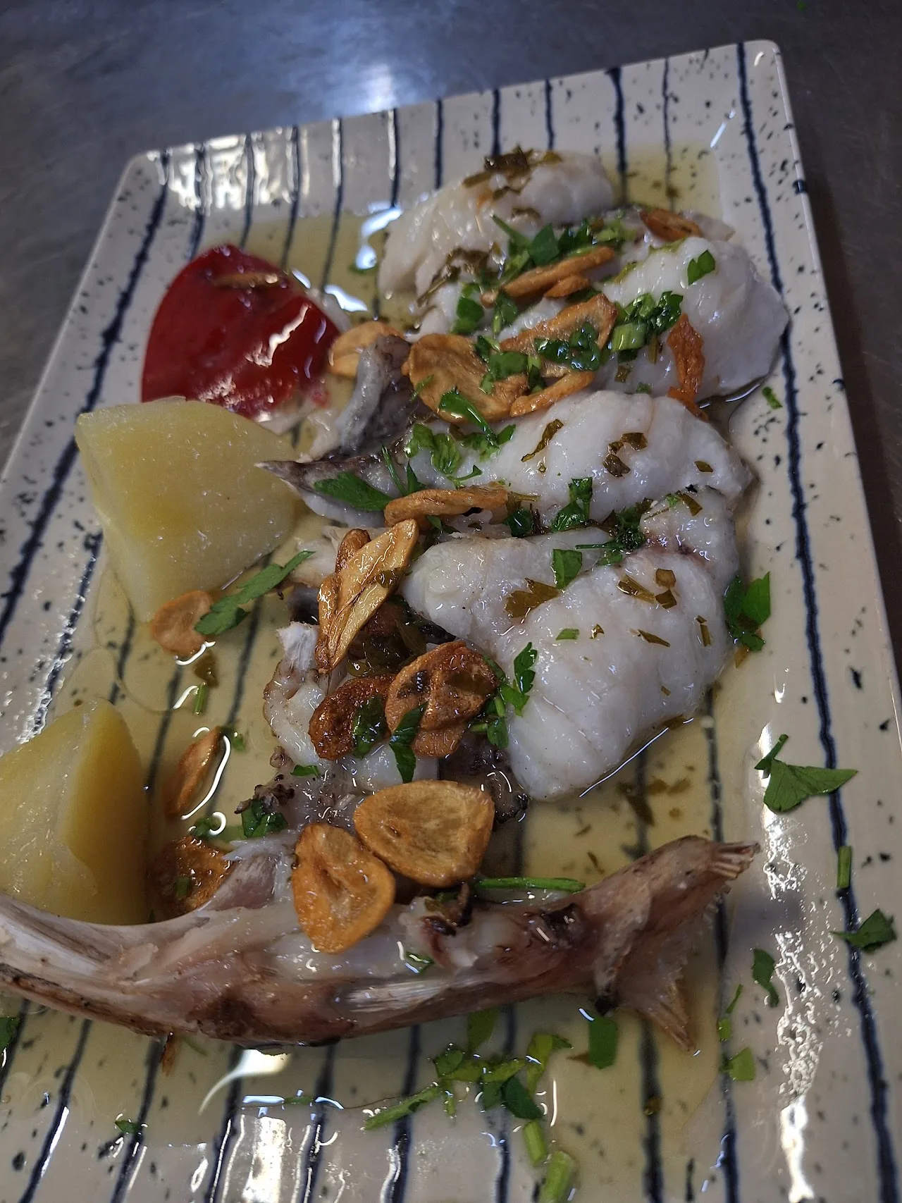 A fish fillet dish garnished with citrus
