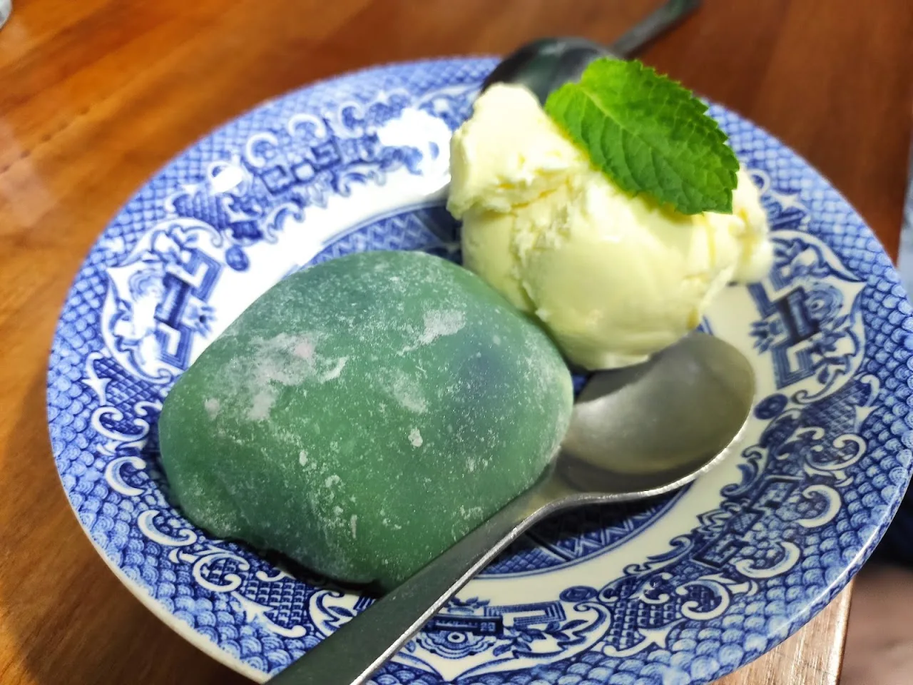 Mochi ice cream balls on a blue and white plate