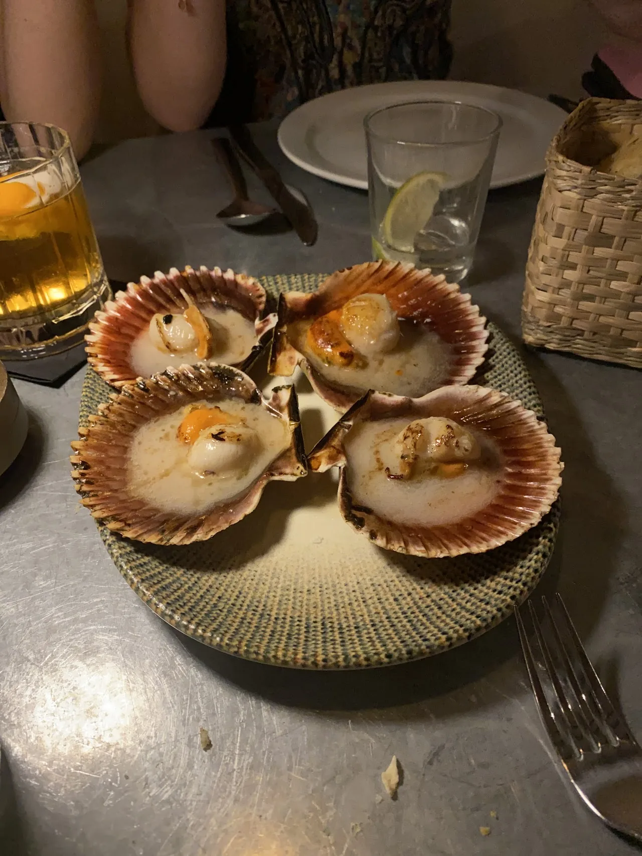 A plate of grilled scallops served in their shells