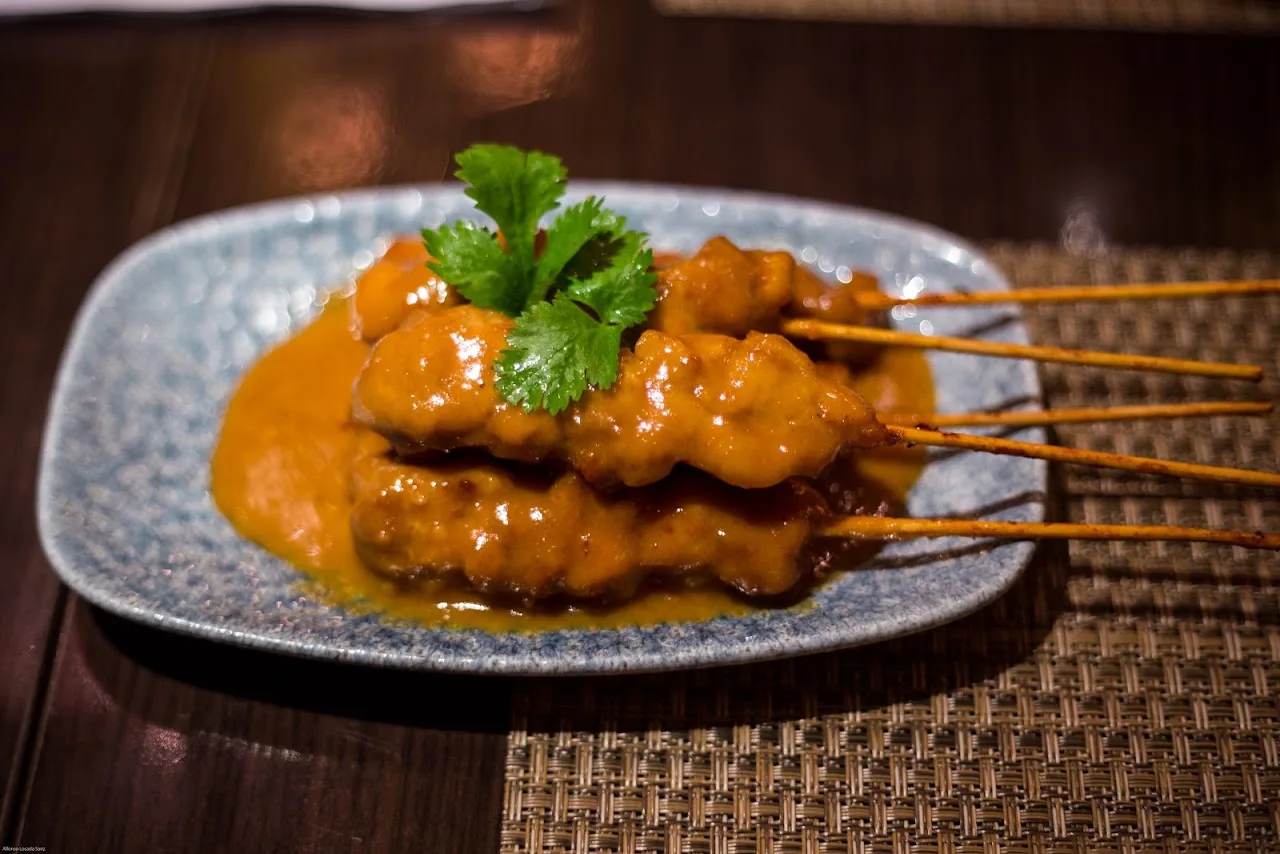 Chicken satay skewers with peanut sauce and cilantro