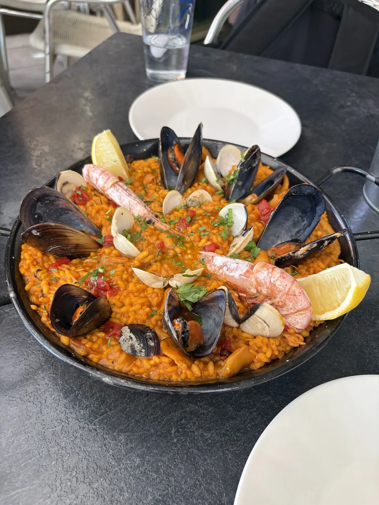 A pan of paella with mussels and shrimp