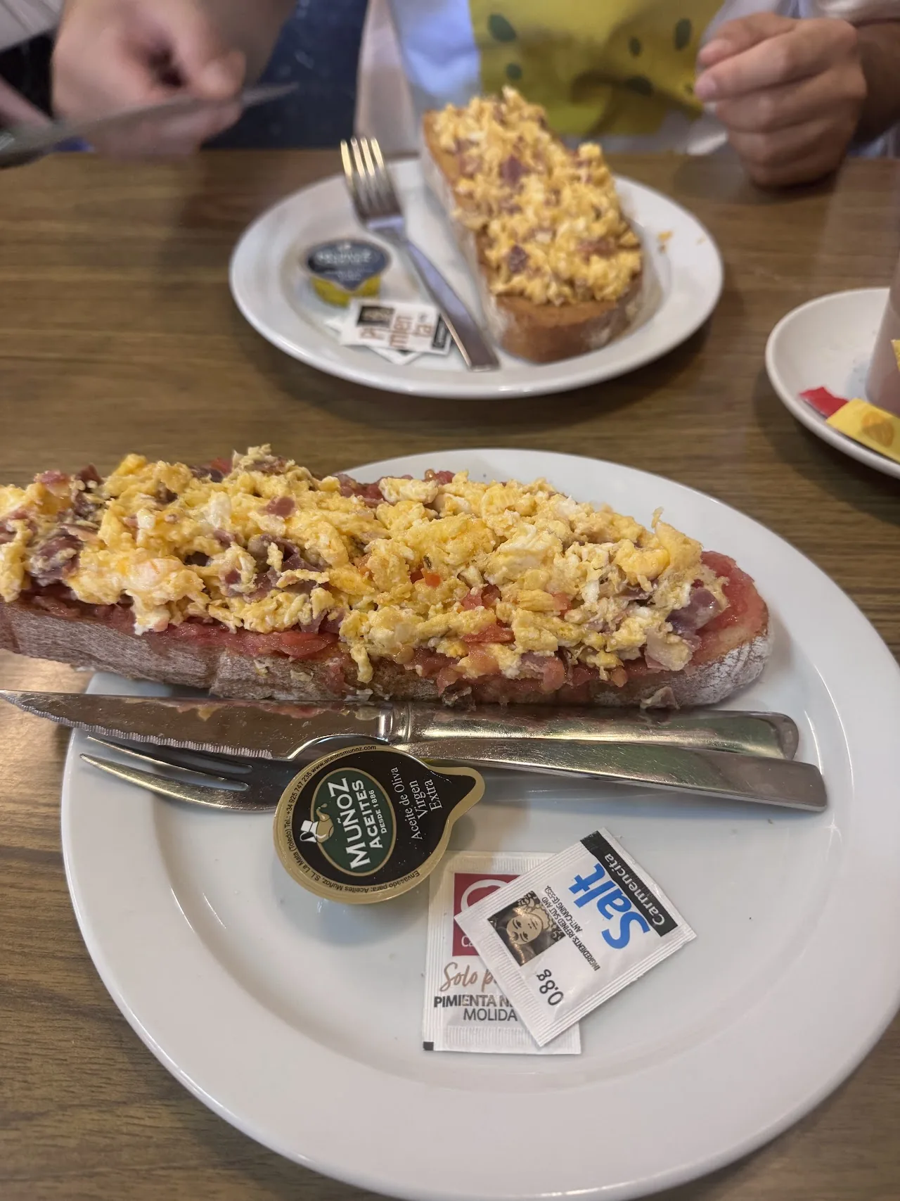 A baguette slice topped with melted cheese and ham