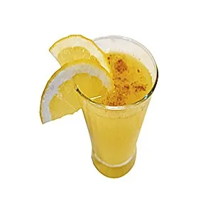 A tall glass of thick orange juice dusted with cinnamon, garnished with two orange slices on the rim