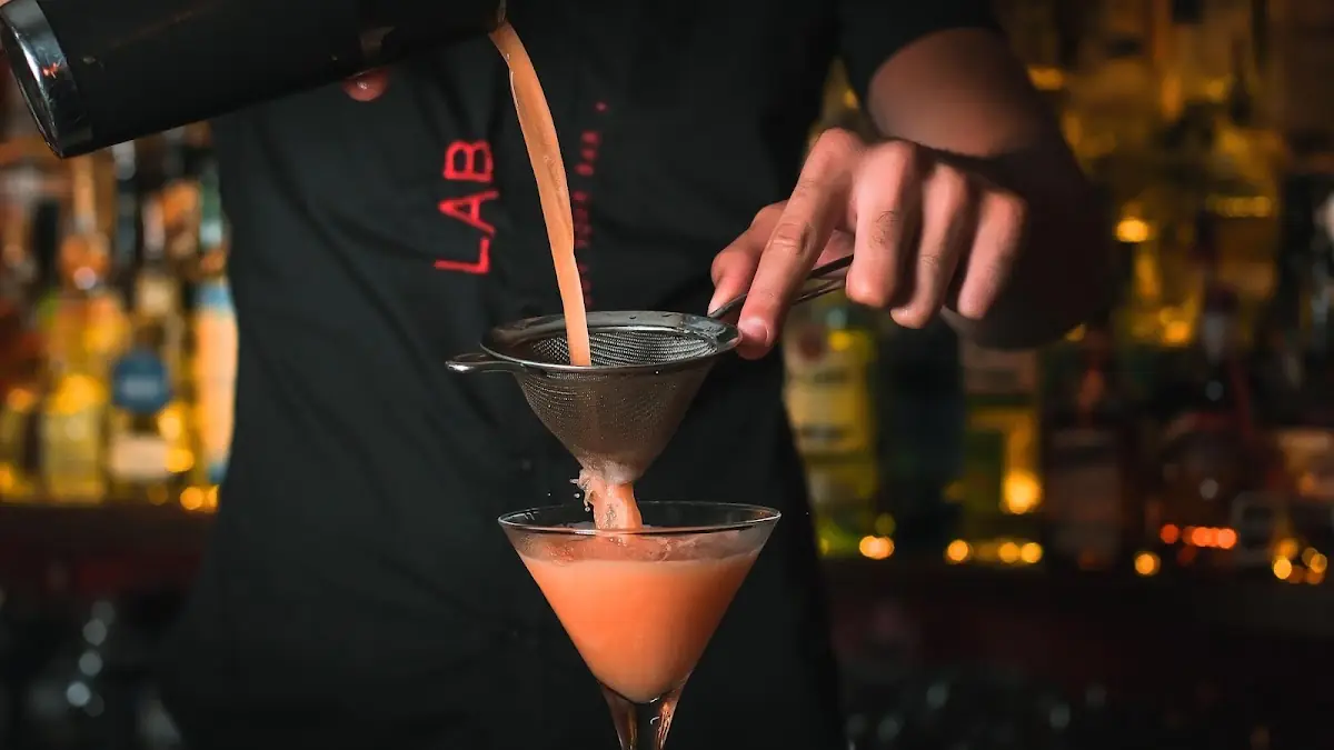 A bartender mixing a cocktail at LAB Cocktail Bar