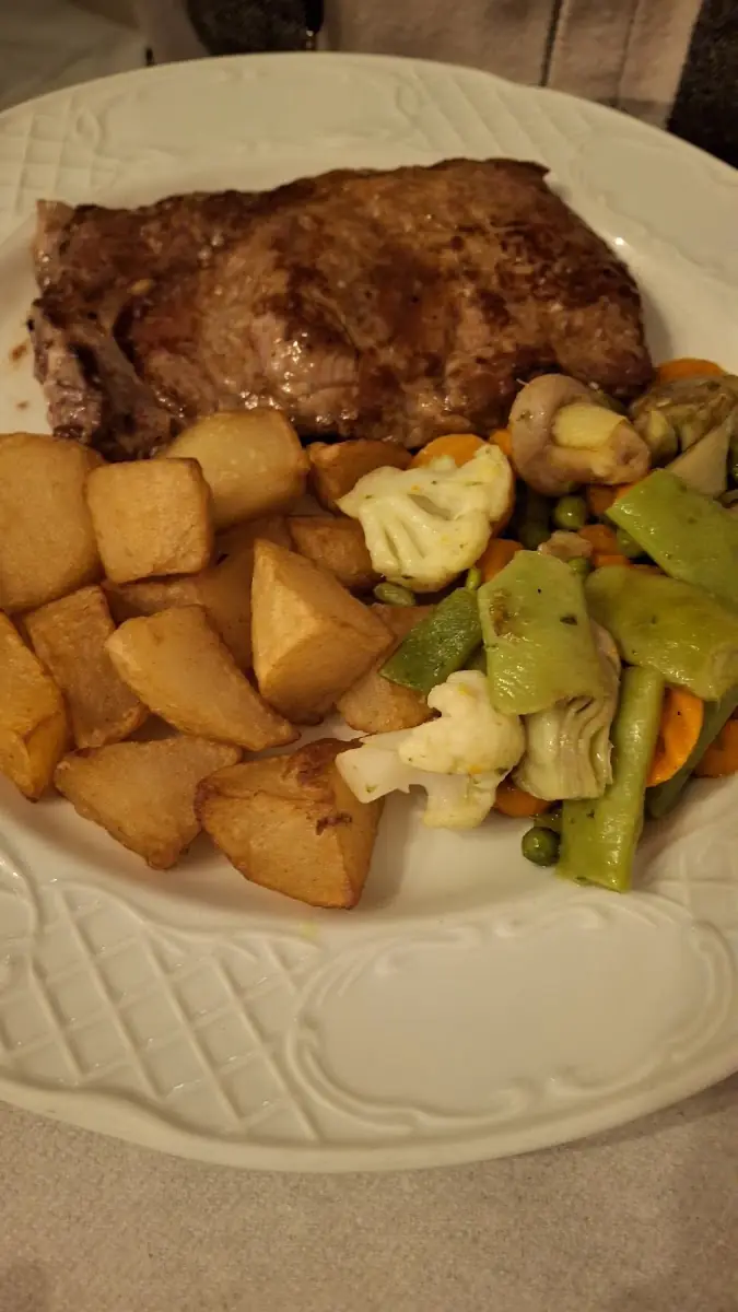 Grilled meat with potatoes and vegetables at Ca'n Punta
