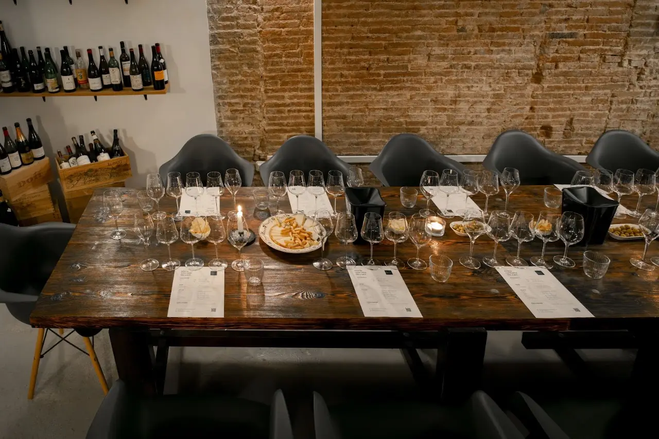 Wine-tasting table set with glasses and small snack plates at Bar Salvatge.