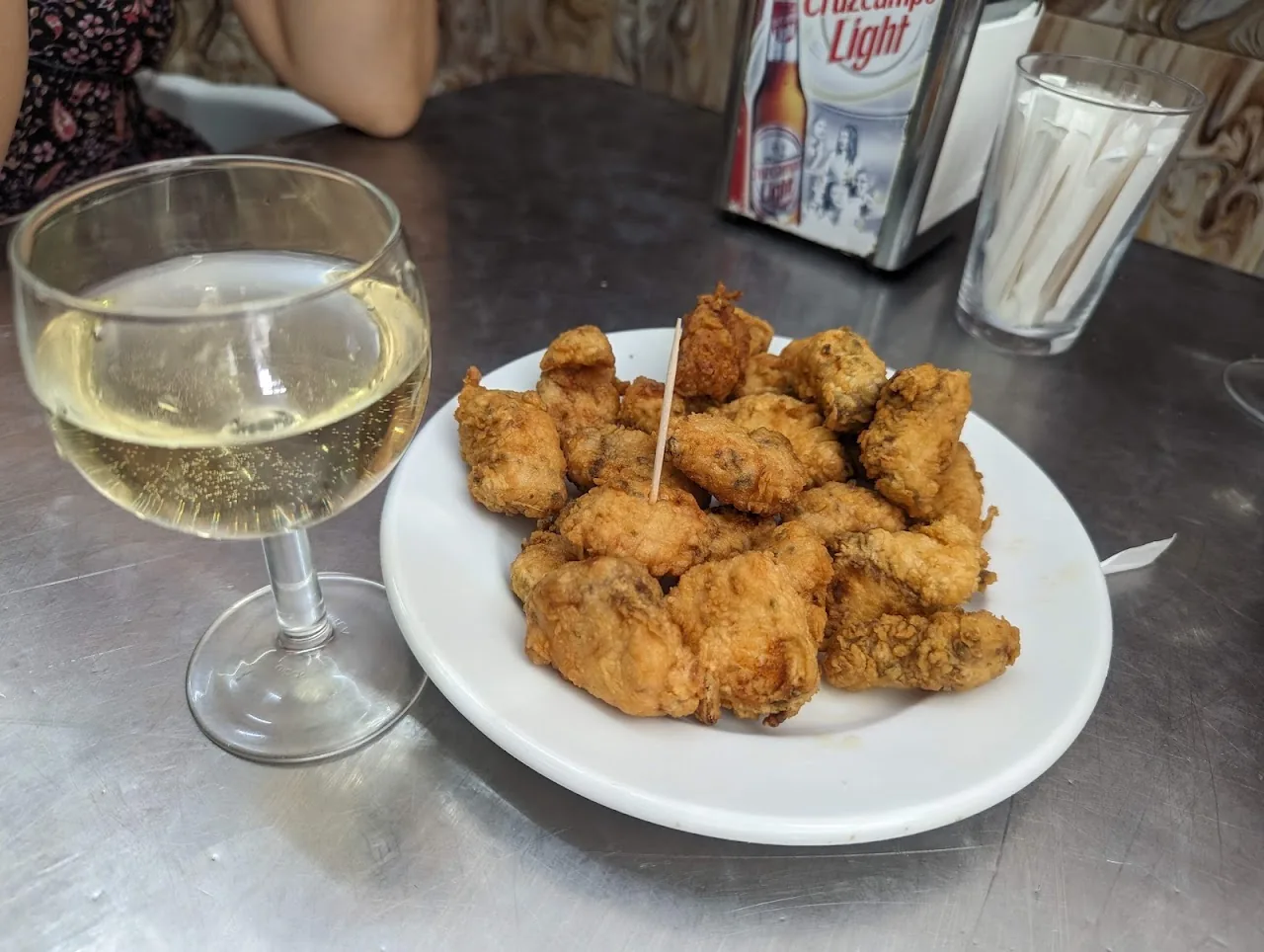 A plate of breaded fried bites on toothpicks