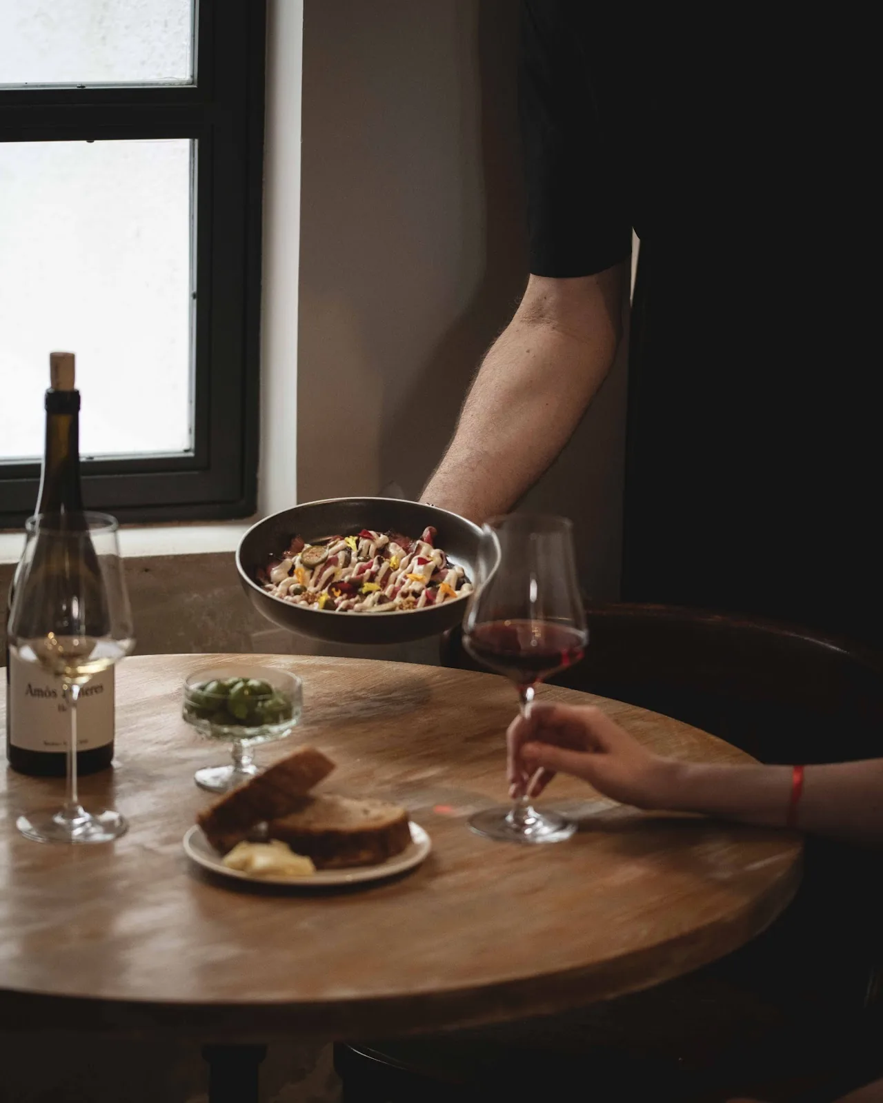 A shared plate of pasta on a wooden table