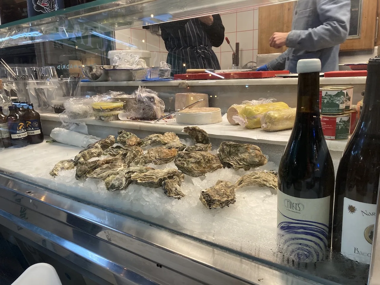 Fresh oysters on ice at a market counter