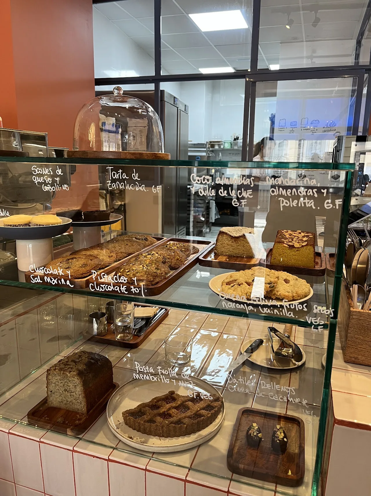 A bakery display case with pastries and loaf cakes