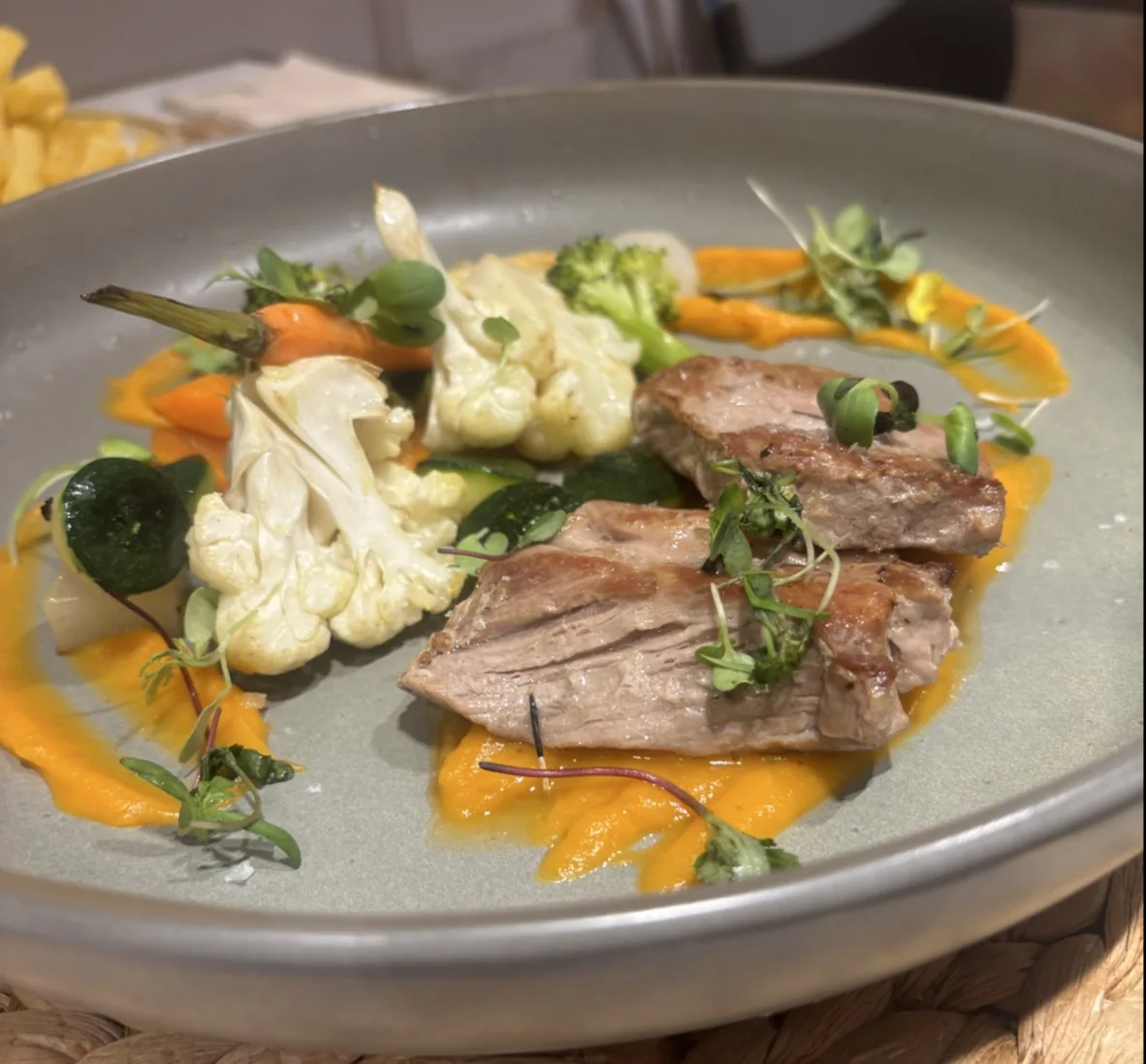Sliced meat with roasted carrots and cauliflower