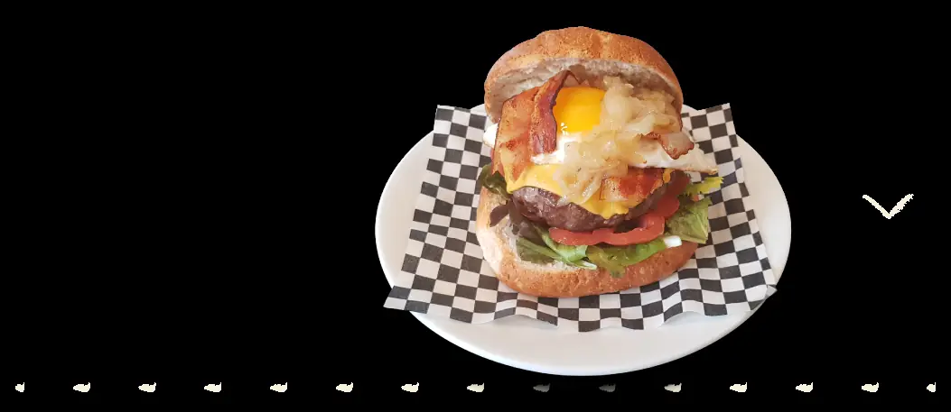 Burger topped with a fried egg, bacon, and caramelized onion at Bodega Pàdua
