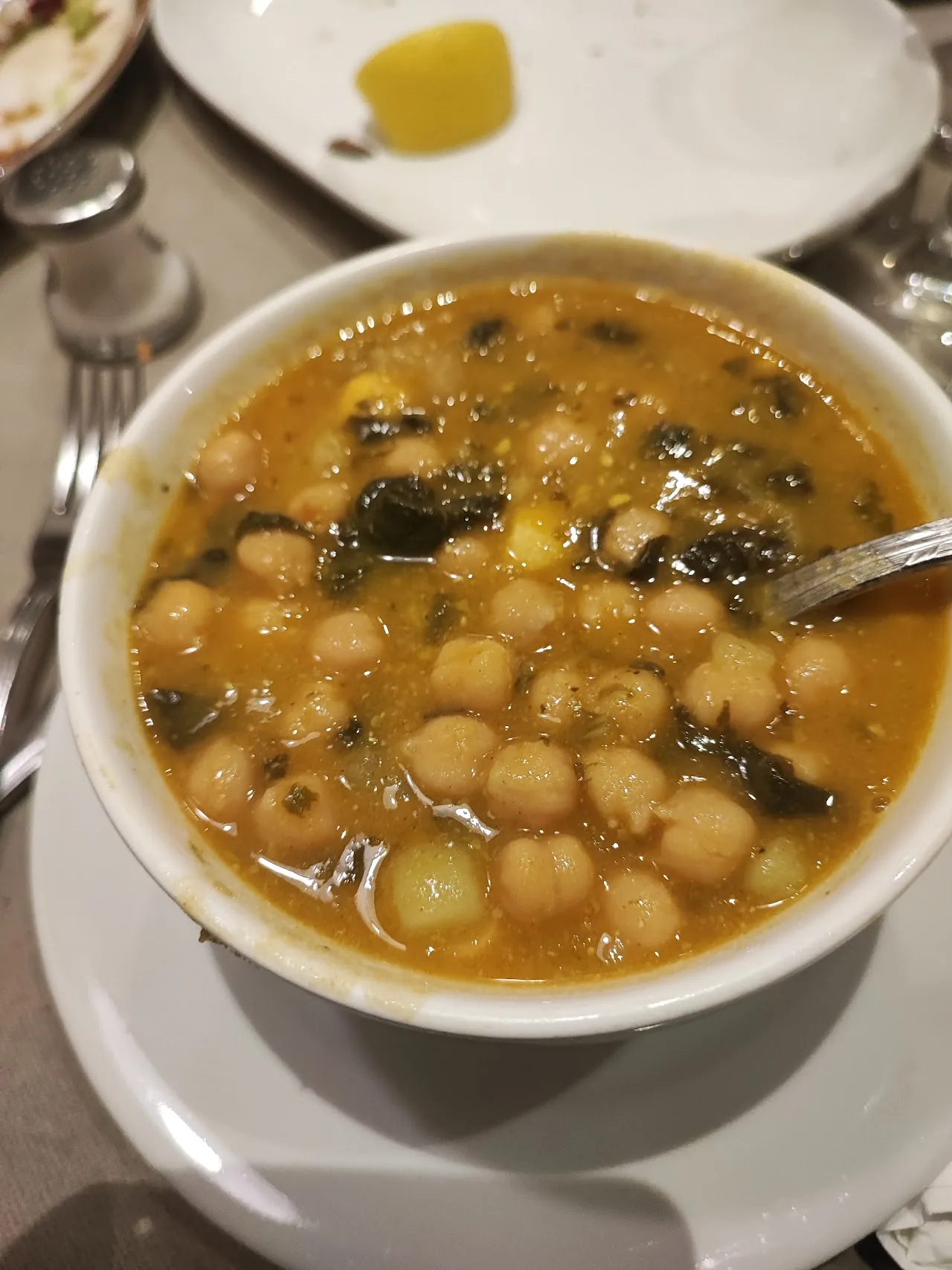A bowl of chickpea and greens soup
