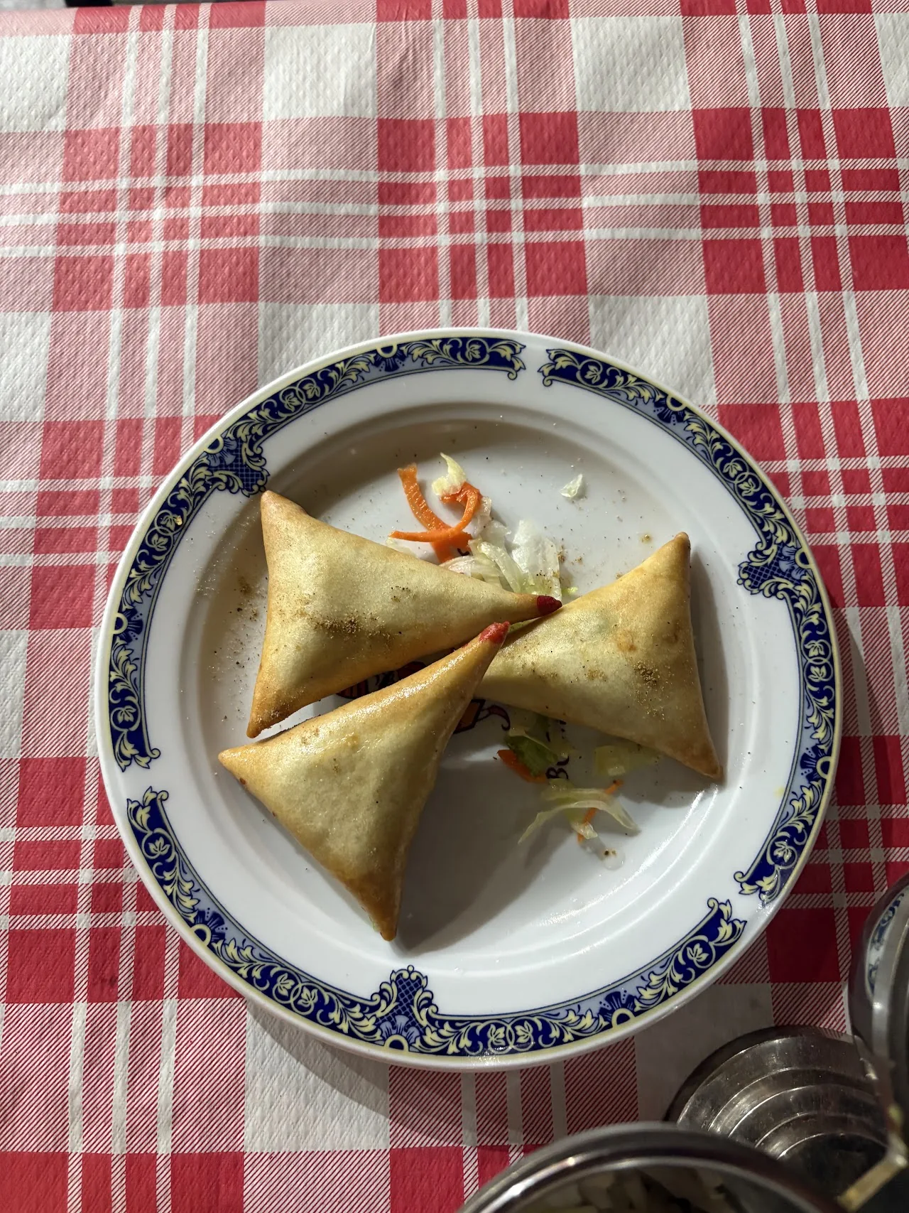 Folded samosas on a plate