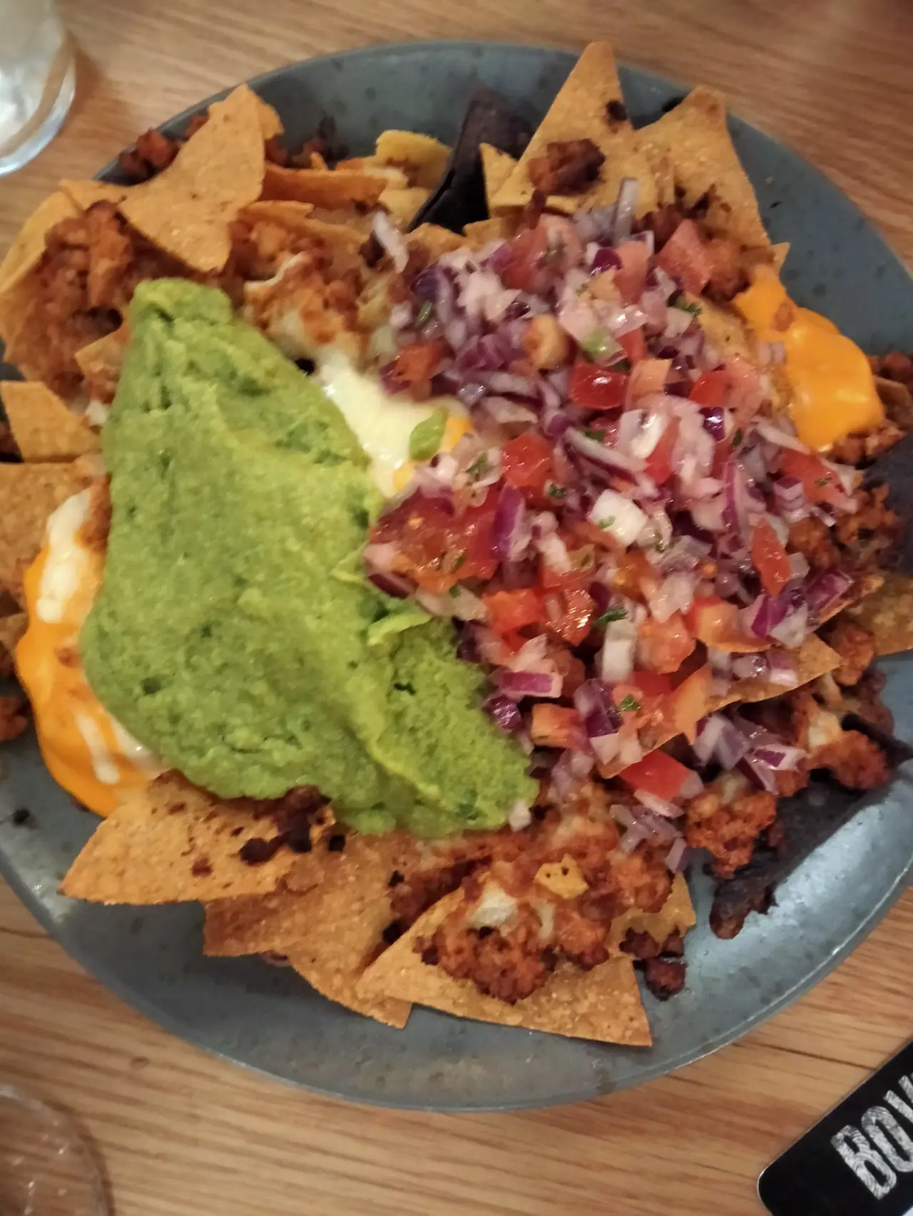 Loaded nachos with guacamole, pico de gallo, cheese and seasoned meat