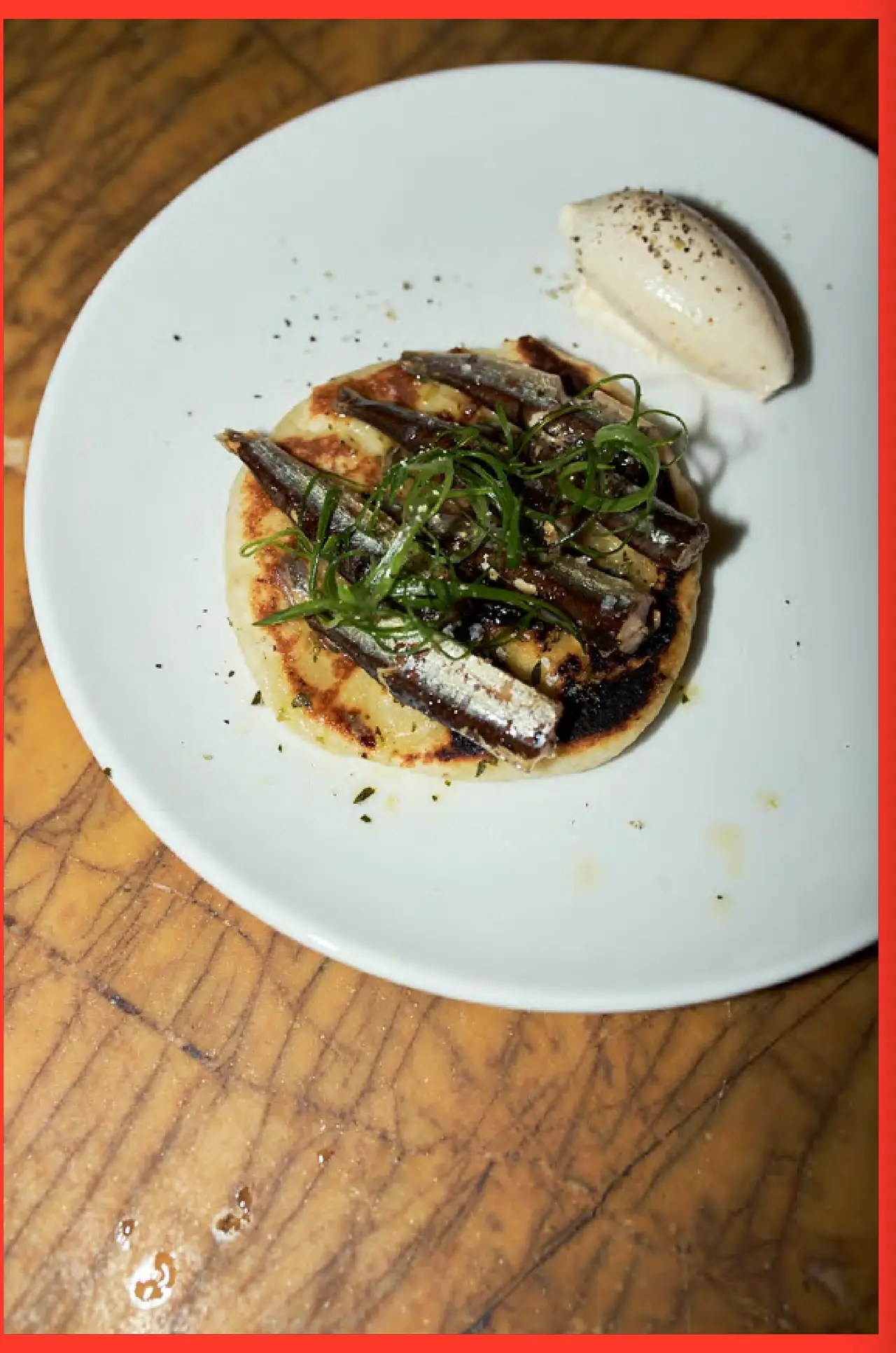 Grilled sardines on charred flatbread with scallions and a quenelle of whipped miso butter, Bar Brutal