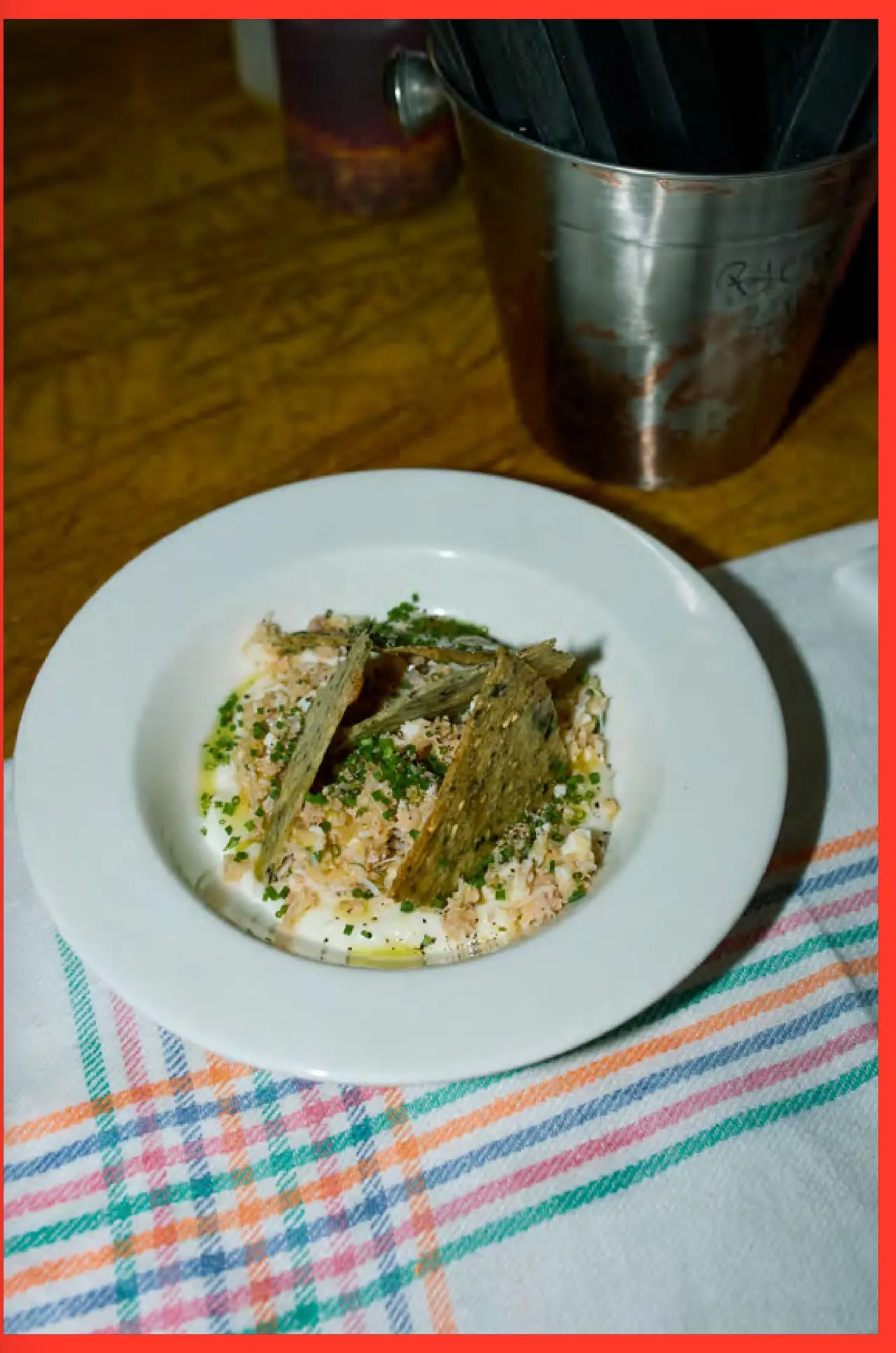 Spider crab salad with crispy seaweed crackers and chives on a white plate, Bar Brutal