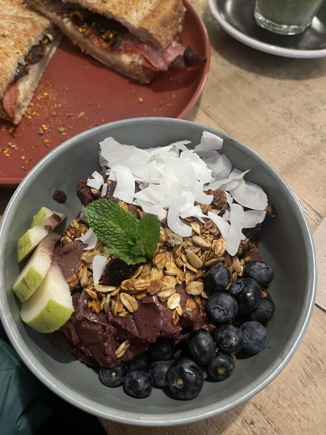 A bowl of granola topped with fruit and coconut