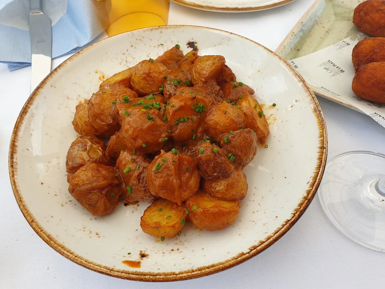 A plate of crispy patatas bravas