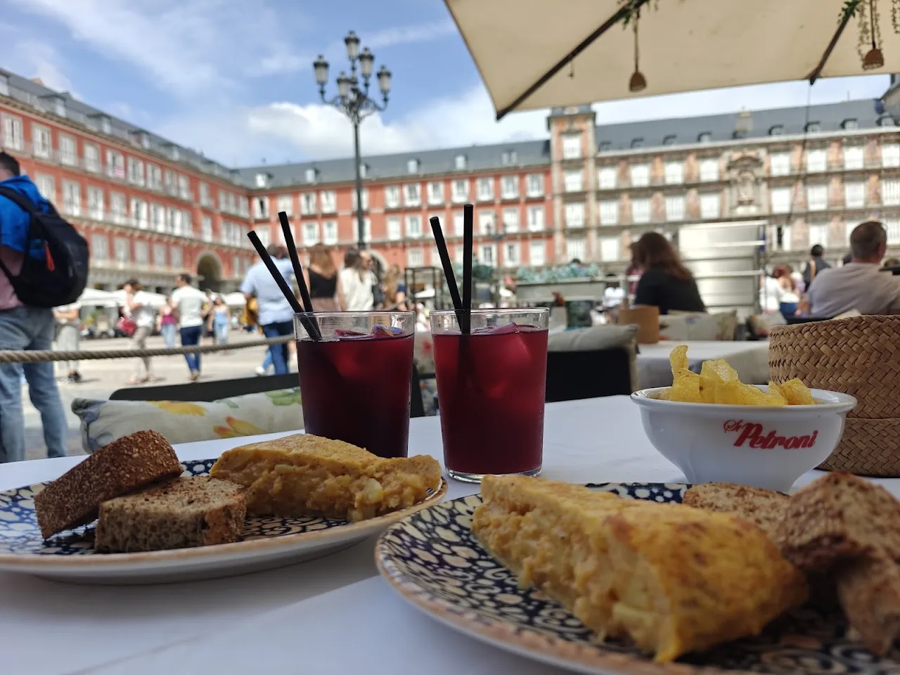 Two red drinks and toasted bread on a table