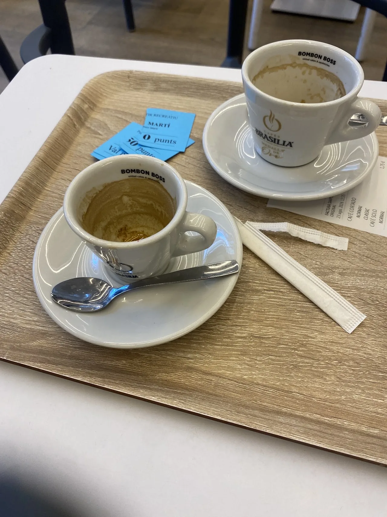 Two cups of coffee on a wooden tray