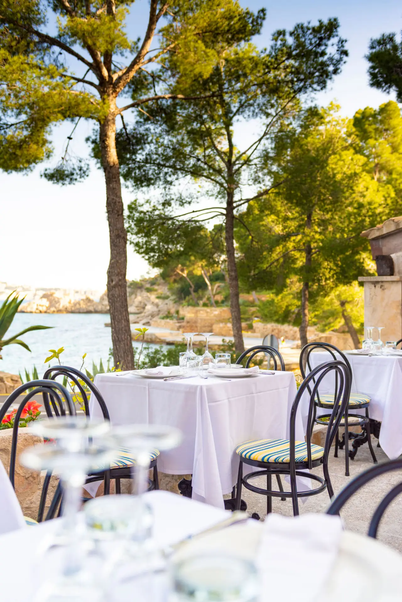 The white-tablecloth dining room at Restaurante Cala Fornells