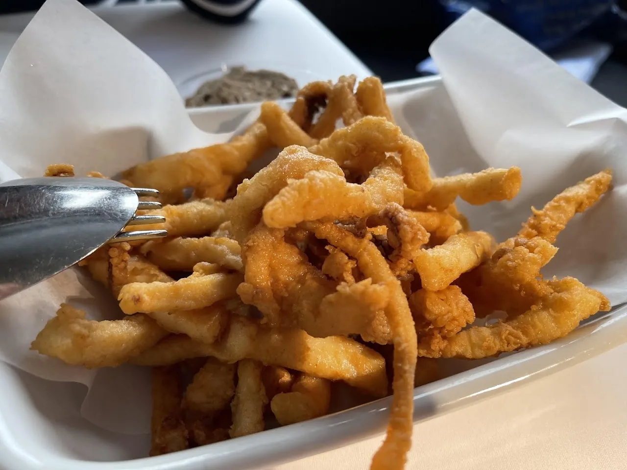 A basket of fried calamari and onion rings