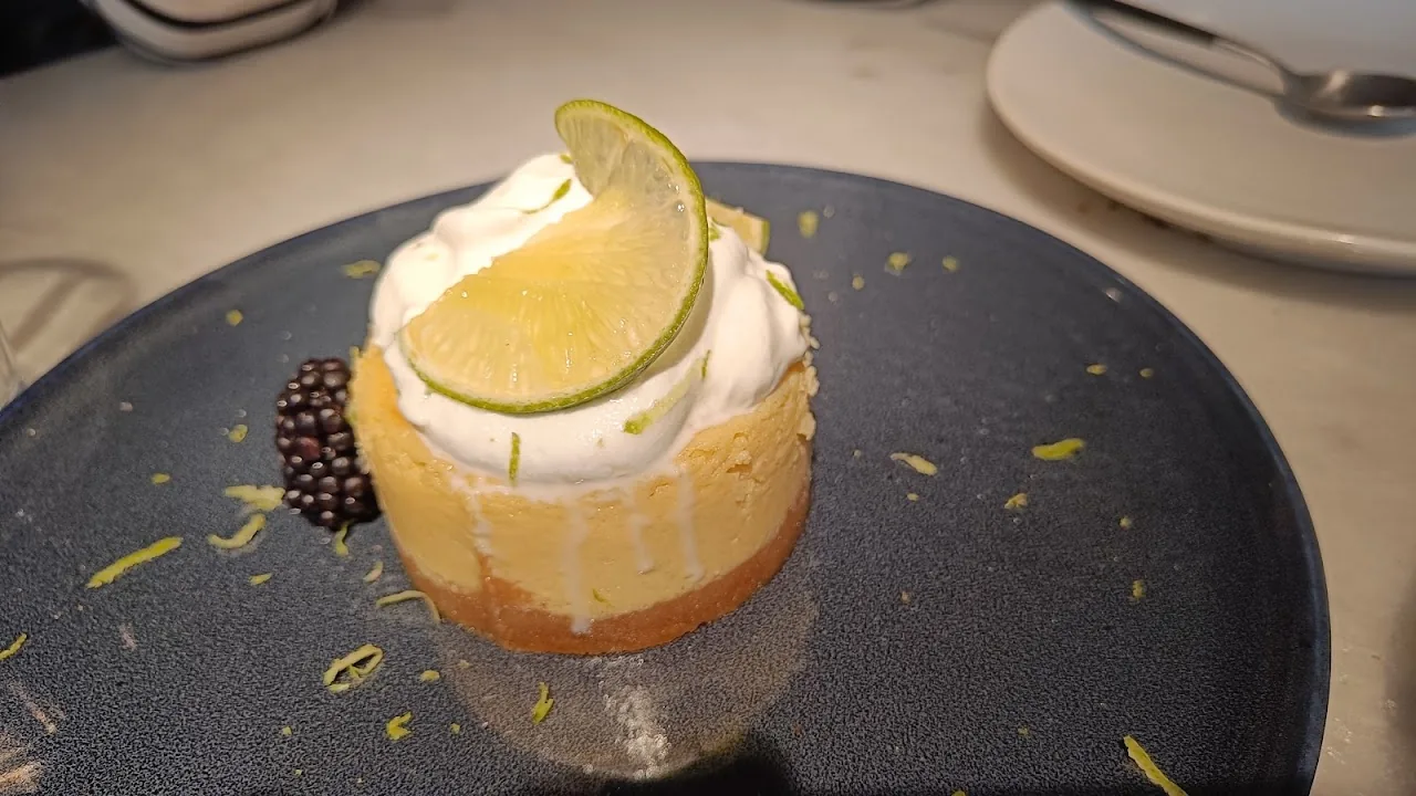 A citrus meringue dessert with a lime wheel on top