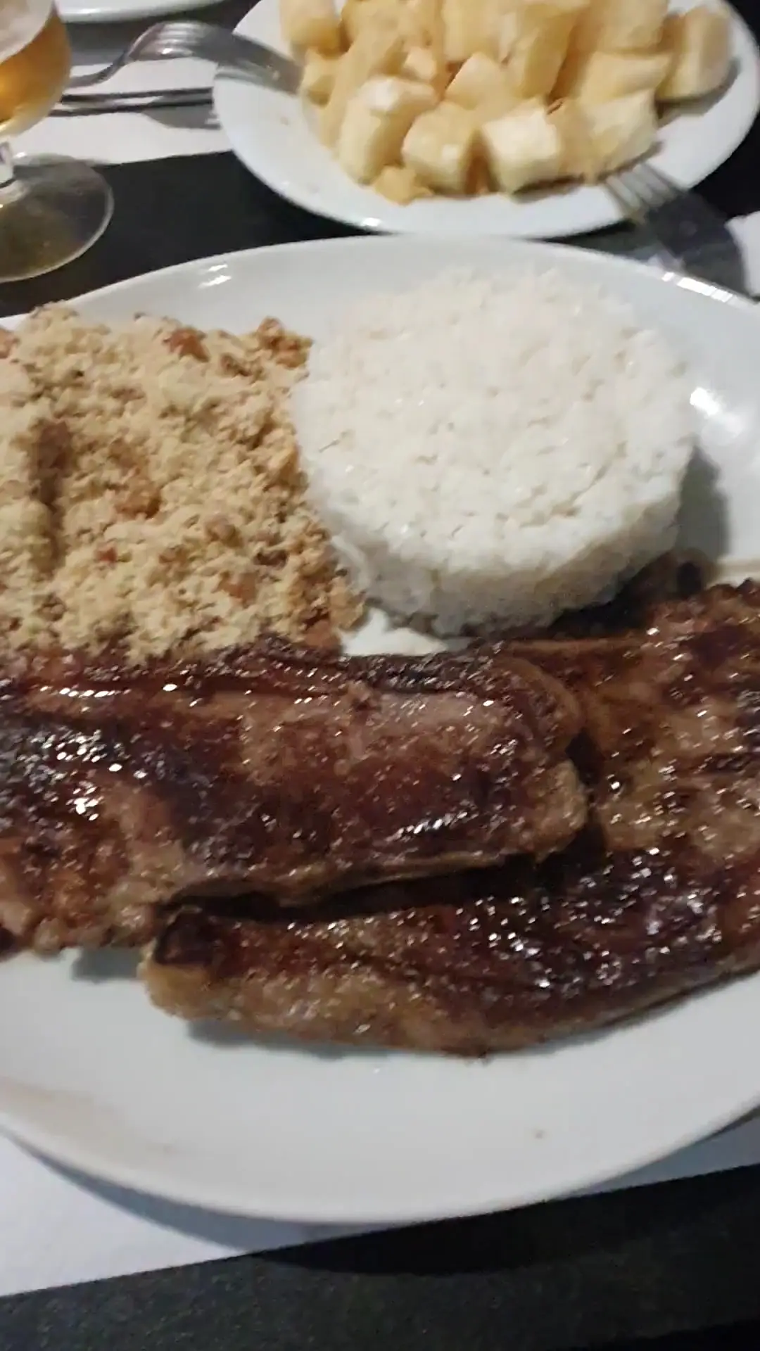 Grilled picanha steak with white rice and farofa, at Cantinho Brasileiro.