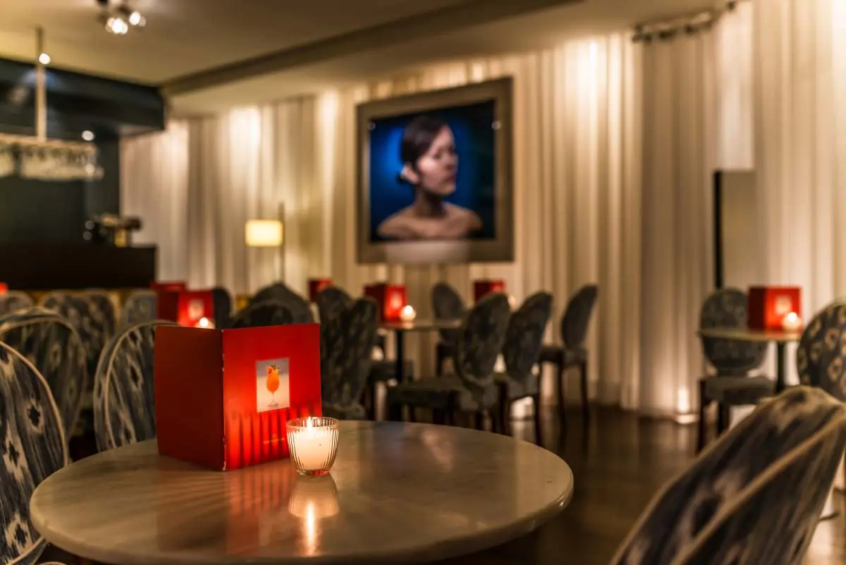 The candlelit indoor room with cane chairs in the evening