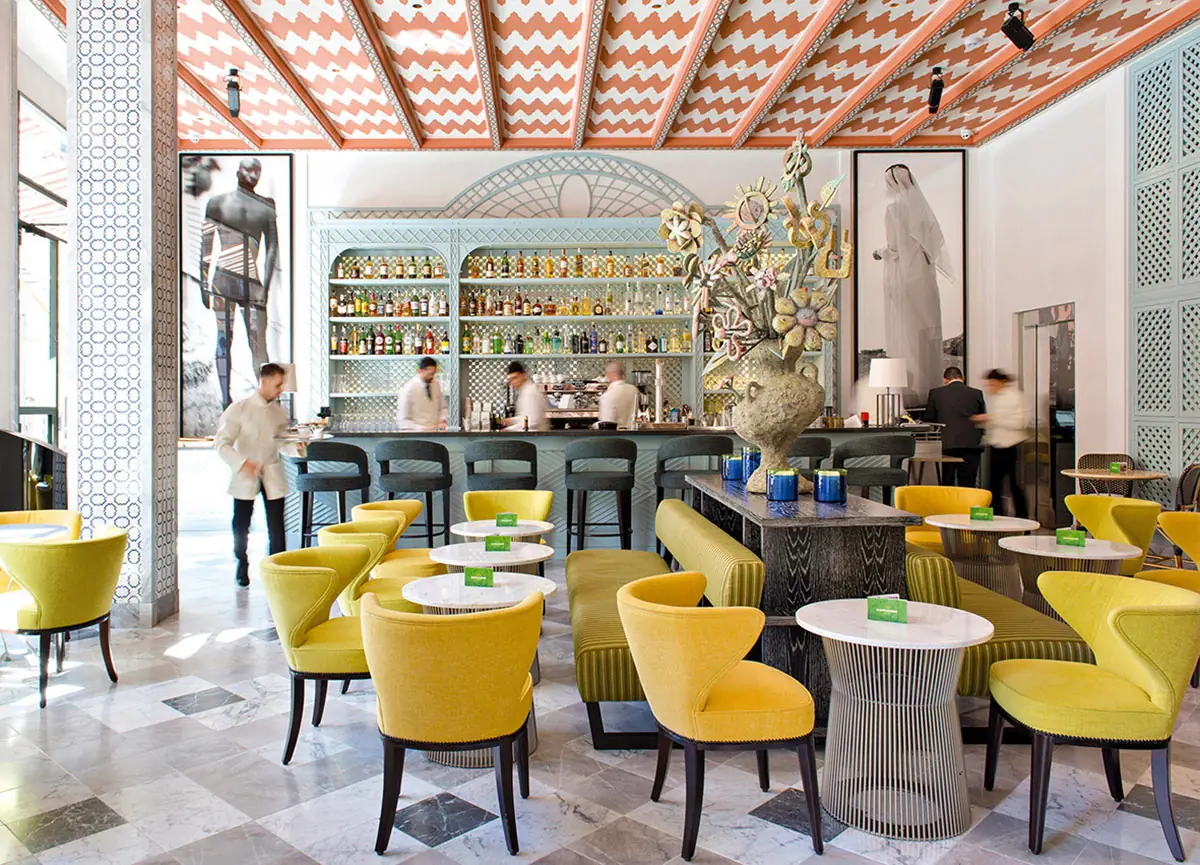 The lounge with yellow chairs and a long bar