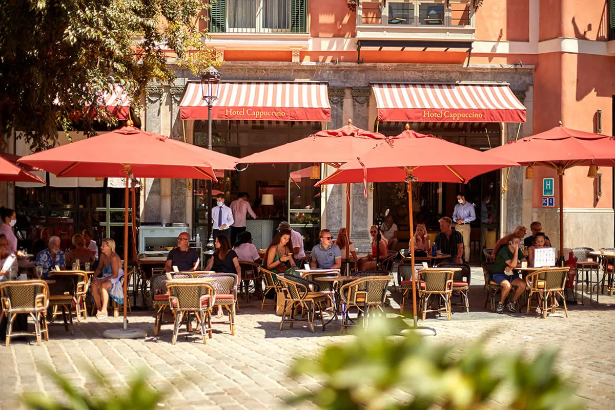 Red parasols over the terrace tables on Plaça de Cort