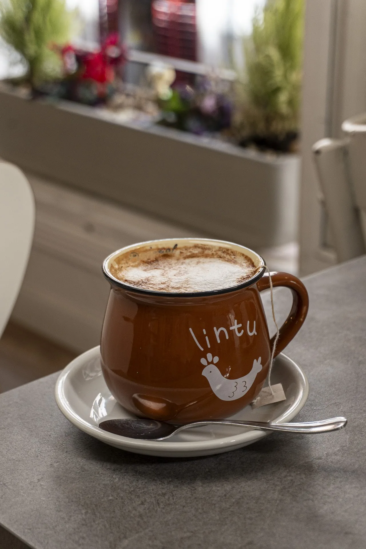 A cappuccino with latte art in a ceramic cup