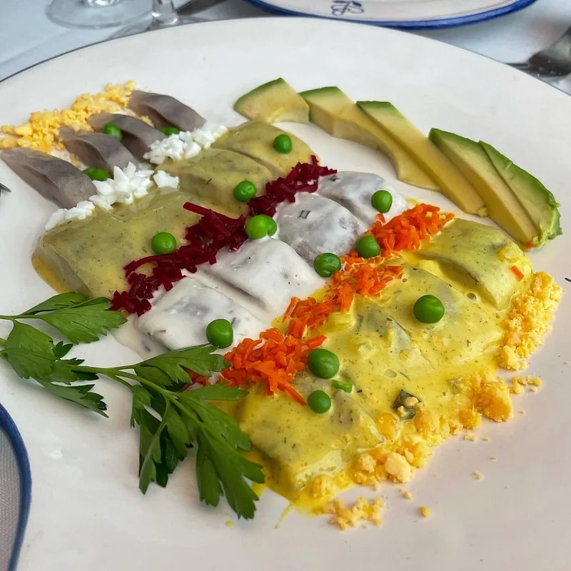 A colorful plate of fish fillets with peas, carrot, and beet garnish