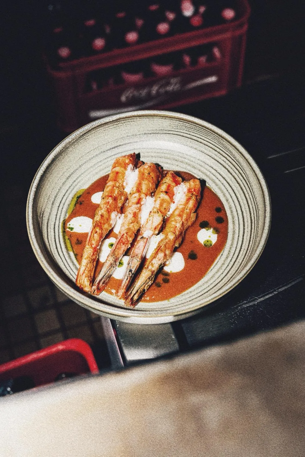 Fried fish or croquette pieces served over a tomato-based sauce