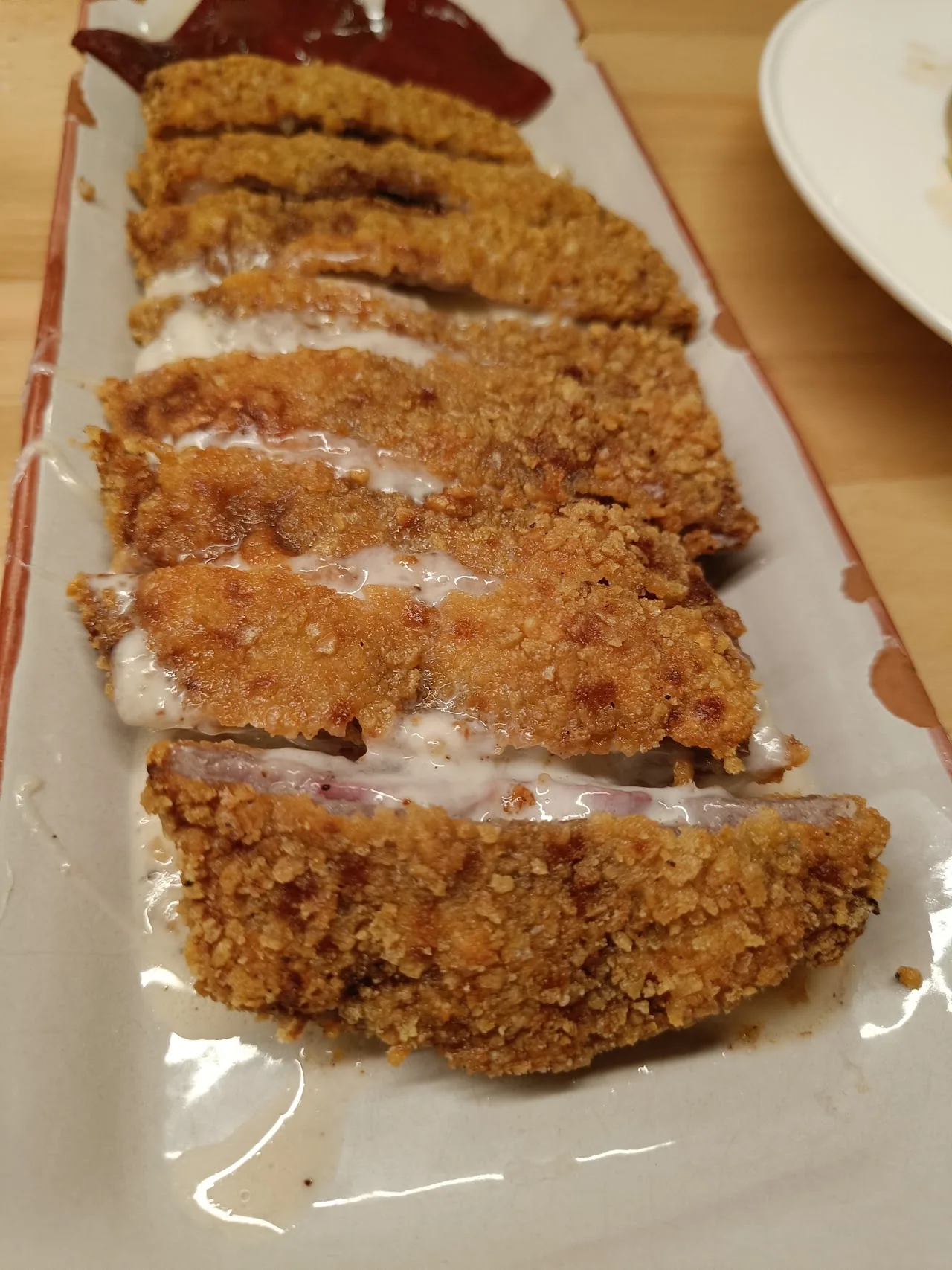 A row of sliced breaded pork cutlets