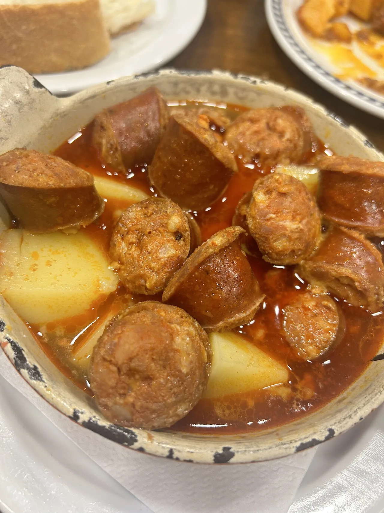 A bowl of white bean stew with chorizo and potato