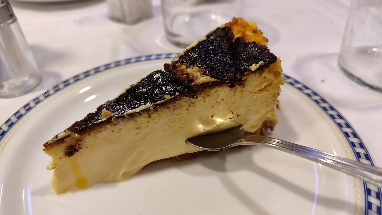 A slice of baked cheesecake with a caramelized top