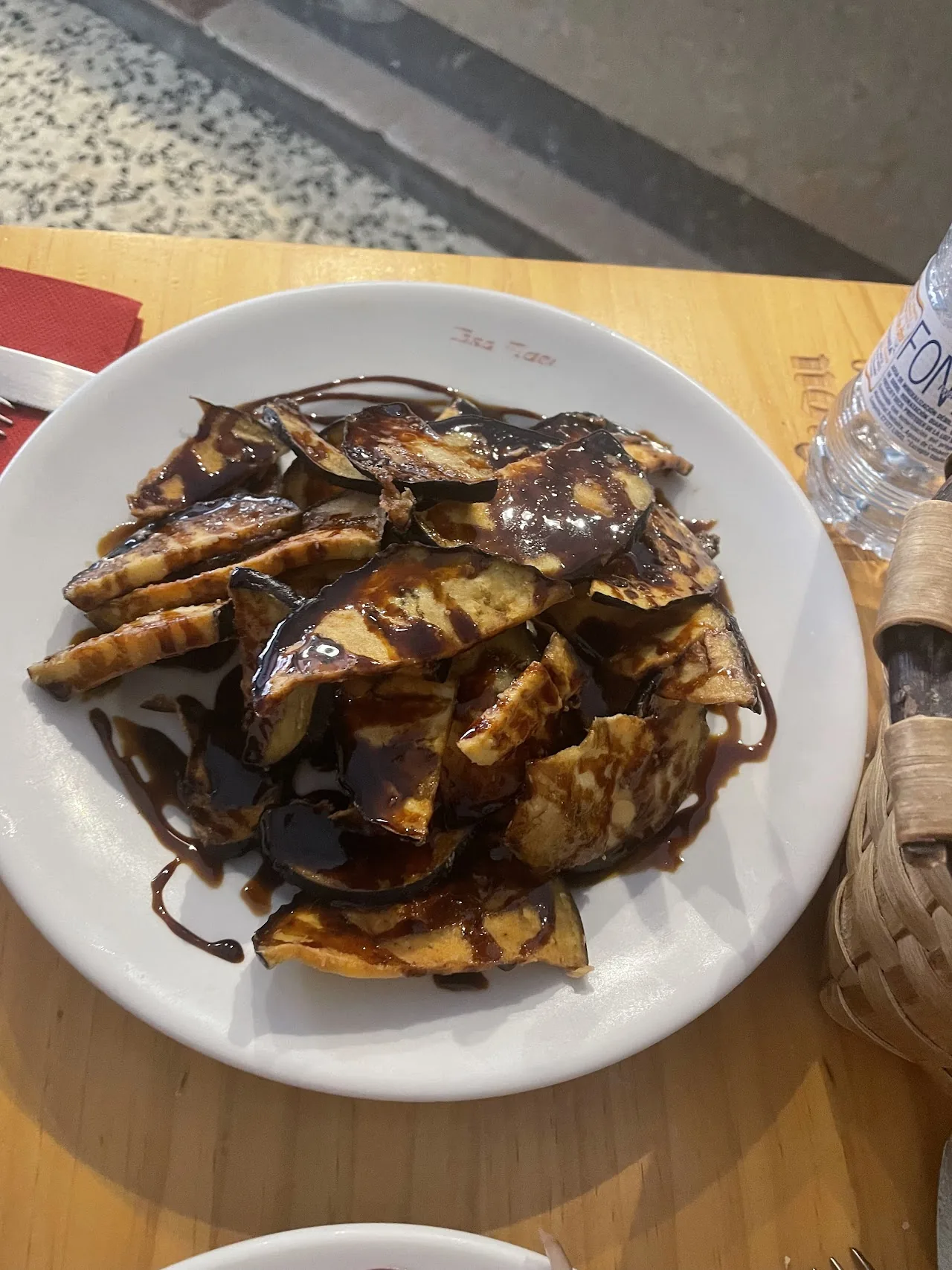 Fried eggplant slices drizzled with a dark glaze