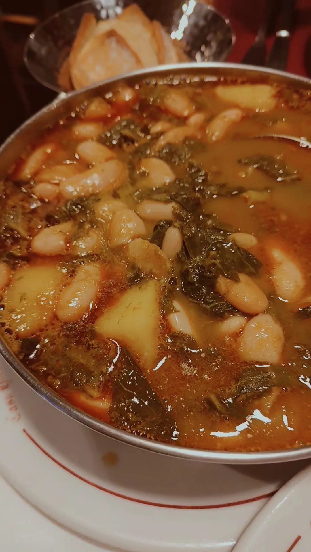 A bowl of white bean stew with chorizo